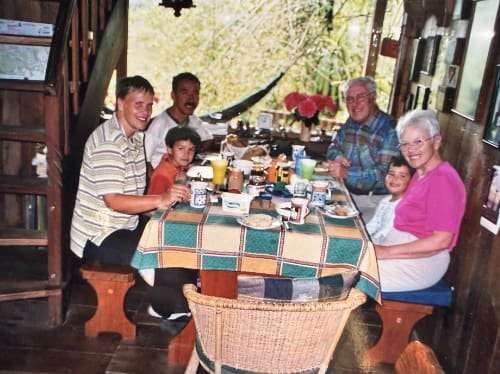 Extended family at the dining room table in Mindo Lindo