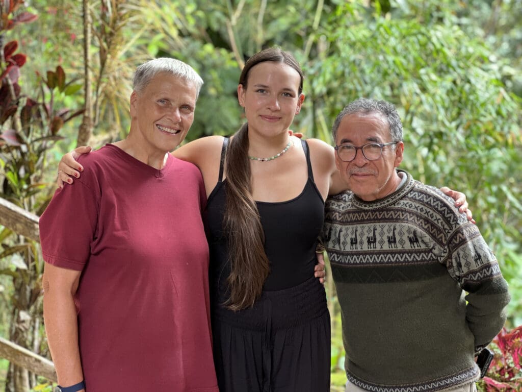 Heike and Pedro embrace their daughter Edith (center)
