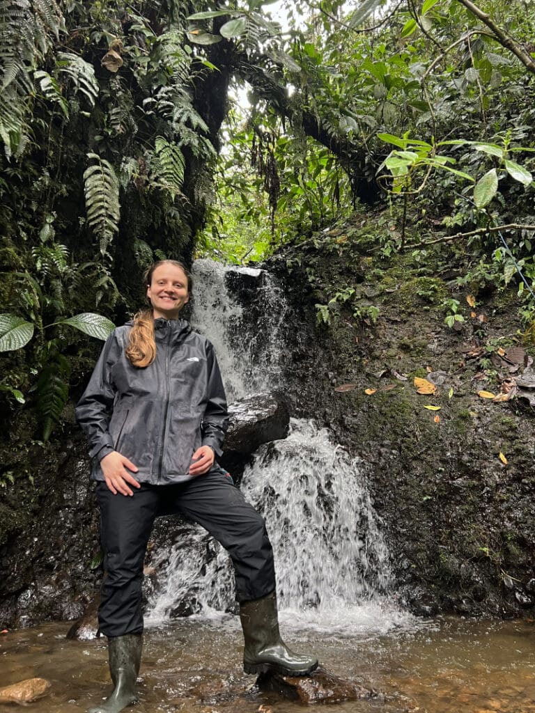 A hiker gets her feet wet along one of the trails at Mindo Lindo
